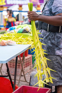 Coconut leaves hang for sale in conjuction of deepavali celebration at the market.