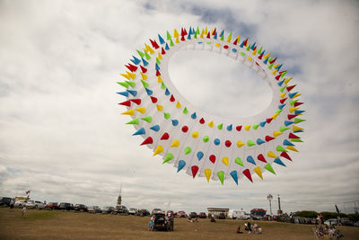 Colorful balloons against cloudy sky