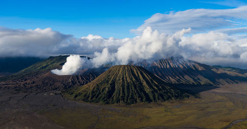 Smoke emitting from volcanic mountain against sky