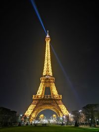 Low angle view of illuminated building against sky at night