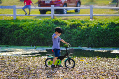Full length of boy riding bicycle at park
