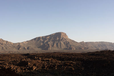 Scenic view of arid landscape against clear sky