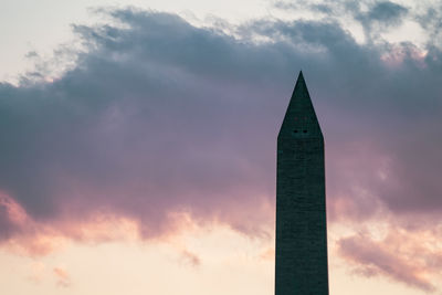 Low angle view of building against dramatic sky