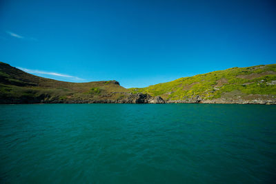 Scenic view of mountains against blue sky