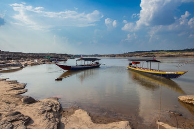 Boat moored on sea against sky