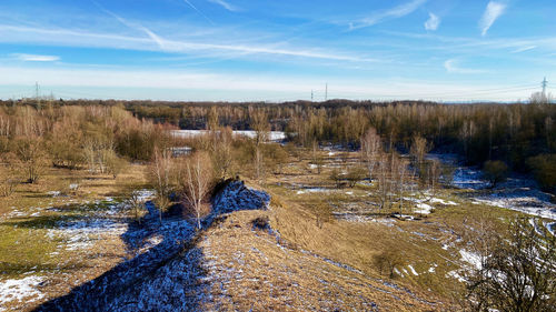 Panoramic view of people on riverbank against sky