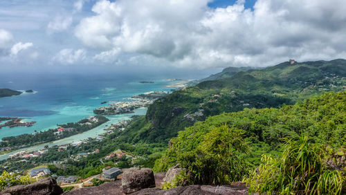 High angle view of sea and mountains against sky