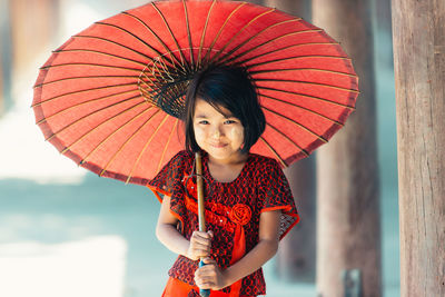 Portrait of woman with red umbrella