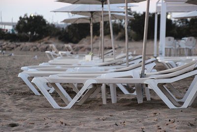 Empty chairs and tables on beach