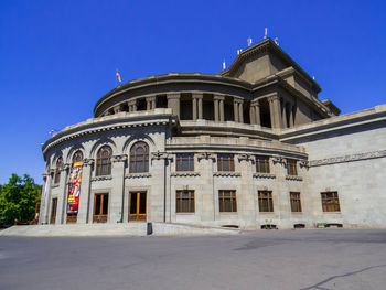 Low angle view of historic building against clear blue sky