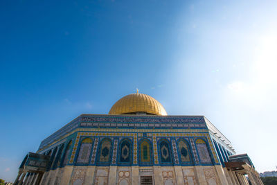 Low angle view of temple against blue sky