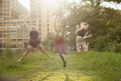 Three young women jumping