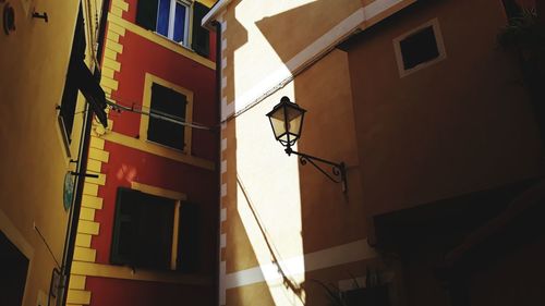 Low angle view of illuminated street light on building