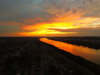 High angle view of cityscape by ohio river against orange sky