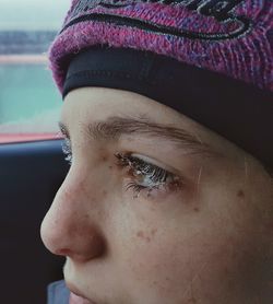 Close-up of woman with water drops on eyes