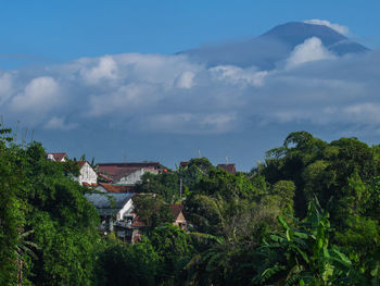 Houses in town against sky