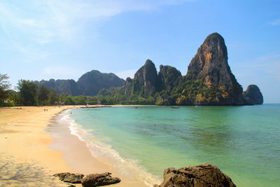 Scenic view of sea and mountains against sky