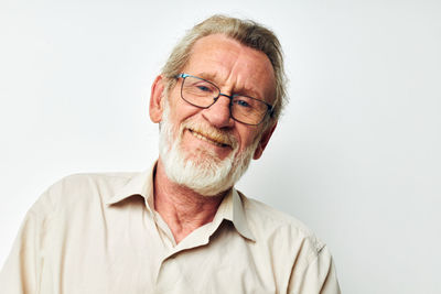 Portrait of senior man against white background