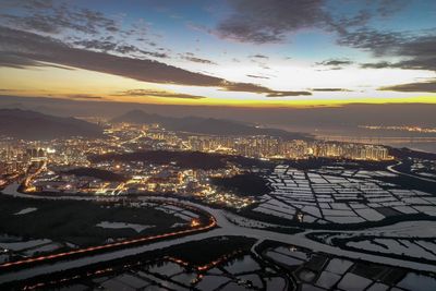 Aerial view of cityscape against sky during sunset