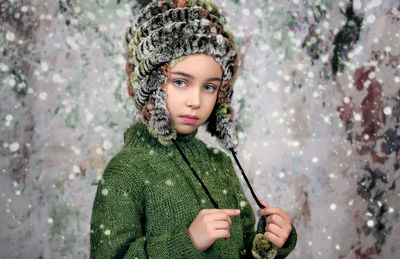 Portrait of girl standing against tree