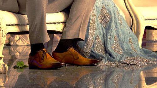 Low section of friends standing on floor