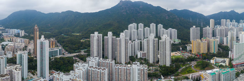 Panoramic shot of modern buildings in city against sky