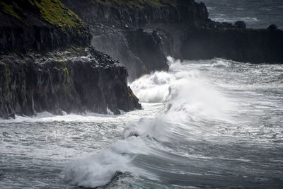 Sea waves splashing on rocks