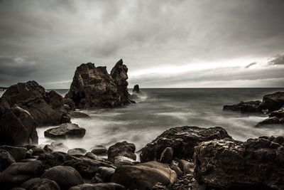 Scenic view of sea against cloudy sky