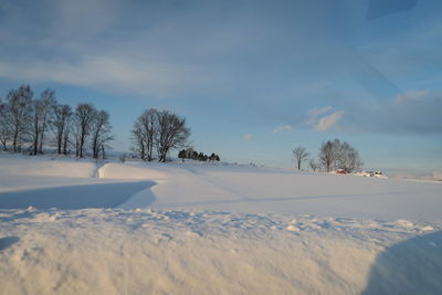 Scenic view of snow covered landscape against sky