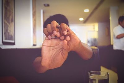 Close-up of man stretching hands in restaurant