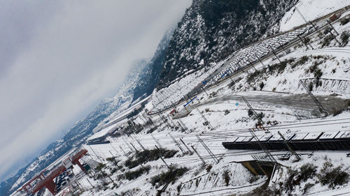 Aerial view of snow covered mountain against sky