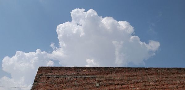 Low angle view of building roof against sky