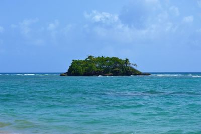 Scenic view of sea against blue sky