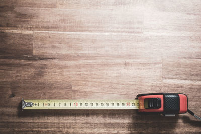 High angle view of tape measure on wooden table