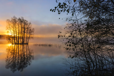 A misty lake at sunrise.