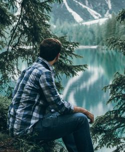 Side view of young man in forest