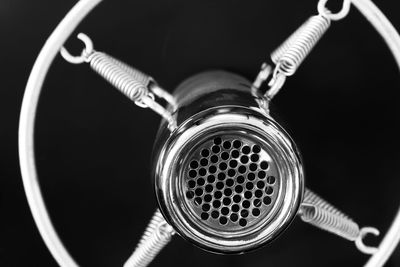 Close-up of vintage microphone against black background