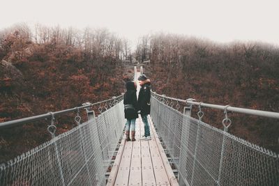 Rear view of man on footbridge