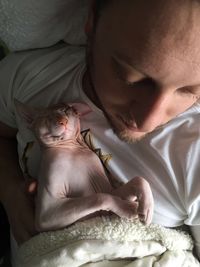 Close-up of baby girl on bed at home