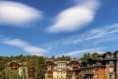 Low angle view of buildings against cloudy sky