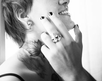Side view of young woman with male hand