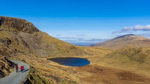 Scenic view of mountains against blue sky