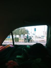 Woman seen through car window