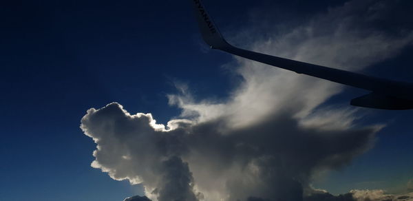 Low angle view of airplane flying in sky
