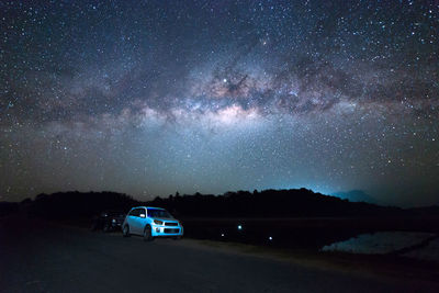 Car on road against sky at night