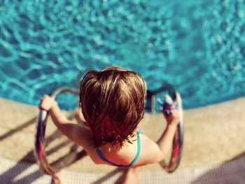 Rear view of young woman in swimming pool