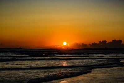 Scenic view of sea against romantic sky at sunset