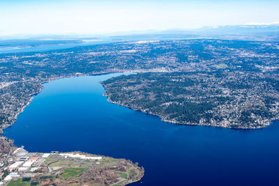 High angle view of sea and cityscape against sky