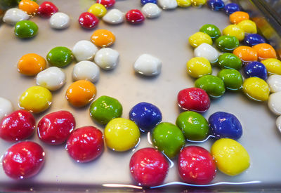 High angle view of multi colored candies on table