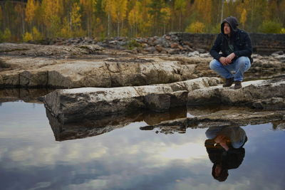 Full length of young woman standing in lake
